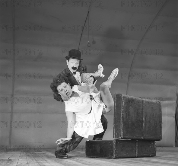 Performance in 1948. The artists under the stage name Arlington perform on the Main Stage. Him wearing a suit, a toupee and a glued-on fake mustache and her in a white dress with something panicky in her eyes as it looks like he's about to place her in the trunk on stage. Conard ref 980