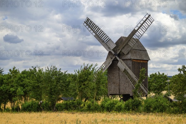A view of a beautiful windmill in Thuringia Germany in a natural setting and an eye catcher for tourists