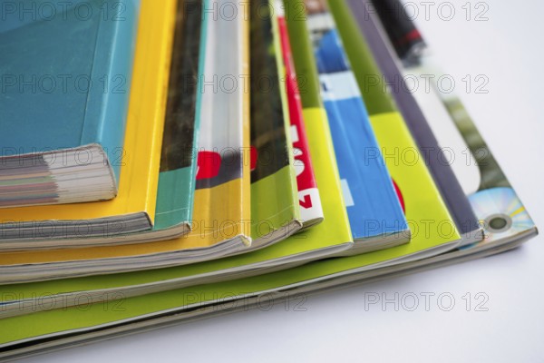 Stack of magazines on white background