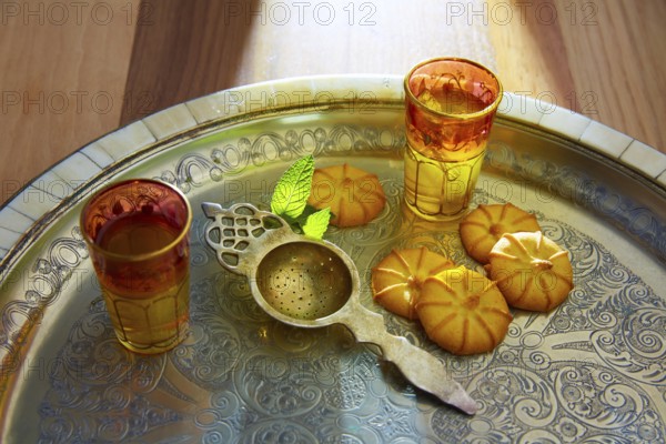 Green tea with mint Moroccan style on silver tray and biscuits