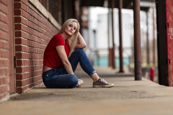 A beautiful blonde woman poses joyfully for the camera, showcasing her stylish spring clothing. With a bright smile and playful demeanor, she radiates happiness, embracing the upcoming gorgeous weather, Charlotte, United States of America
