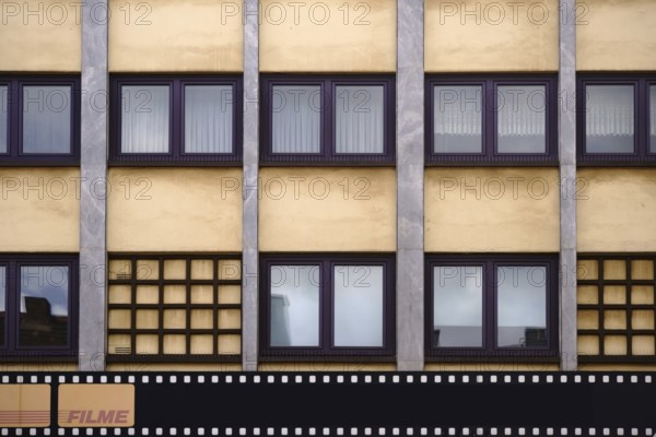 The exterior facade of a photo shop with a painted film strip