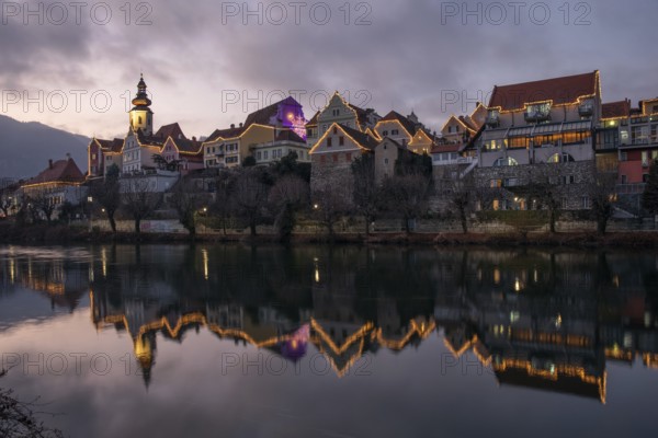 Christmas illuminated house facade of Frohnleiten reflected in the river Mur, Frohnleiten, Styria, Austria, Europe
