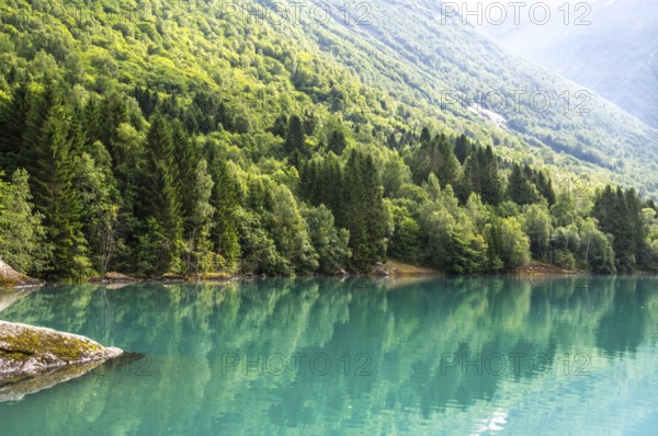 The Kjenndalsbreen is part of the Jostedalsbreen, one of the largest glaciers in Norway, and forms an impressive mountain landscape with a beautiful lake in Sande. The glacier Kjenndalsbreen with a lake in Norway is a beautiful place to travel to in summertime