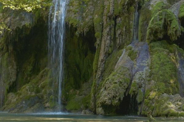 The tufa waterfall near Arbois. Crystal clear waterfall, powerful waterfall