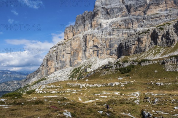 Male mountain climber on a Via Ferrata in breathtaking landscape of Dolomites Mountains in Italy. Travel adventure concept