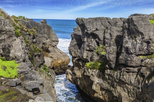 Narrow fjord among unique pancake rocks, natural wonder of Paparoa National Park. Scenic coastline, huge rocks. South Island, New Zealand. The concept of ecological, active and phototourism