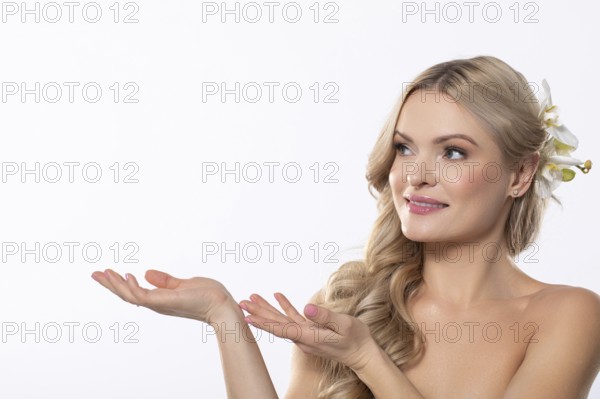 A stunningly beautiful woman is gracefully presenting herself with elegant floral accents in a serene atmosphere