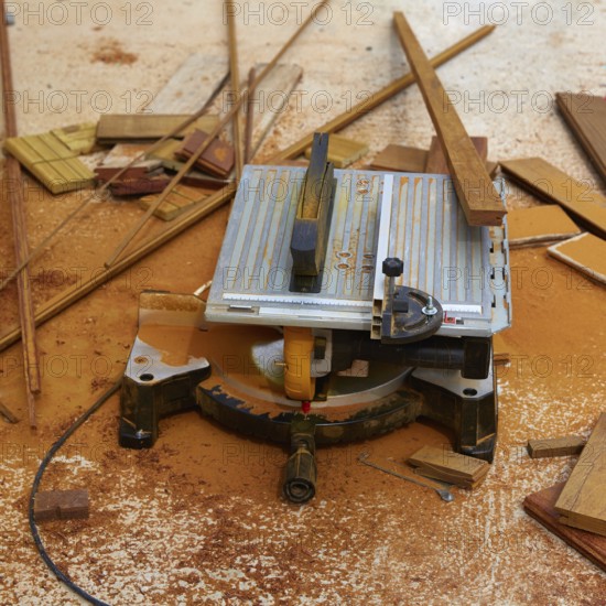 Circular table saw carpenter tool and sawdust in deck installation