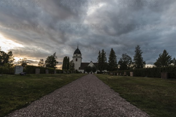 Rattvik, Dalarna, Sweden, 08 05 2019: View over the cloudes graveyard and the small church at dusk, Europe