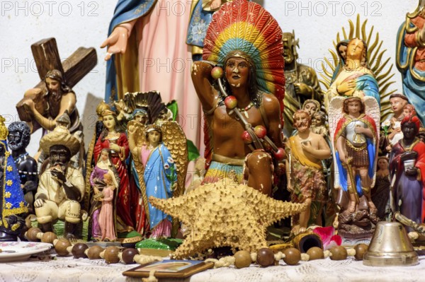 Altar with several images of saints, entities from religions of African origin such as Umbanda and Candomble and everyday objects in a good representation of Brazilian religious syncretism
