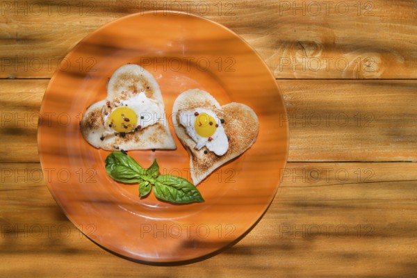Breakfast of toast and eggs in the shape of heart