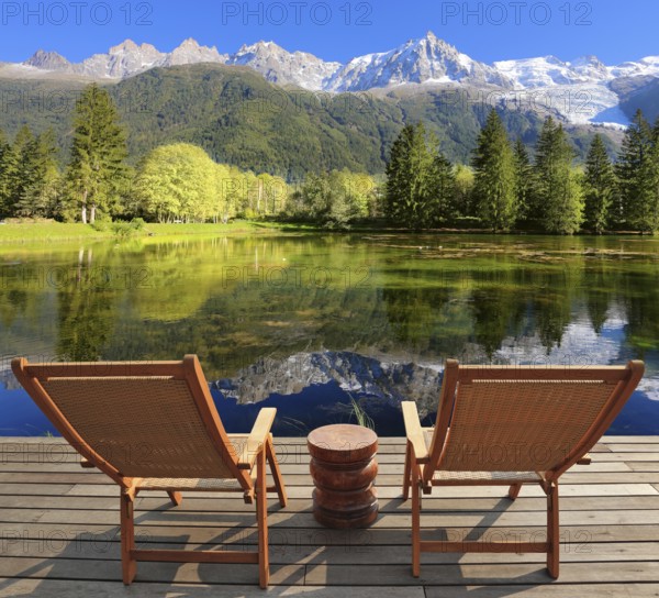 Comfortable lounge chairs on wooden platform for rest and observation. City park in the Alpine resort of Chamonix