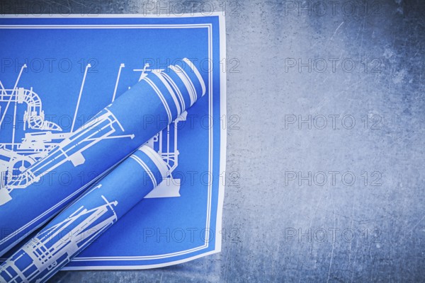 Blue construction plans on metallic background maintenance concept
