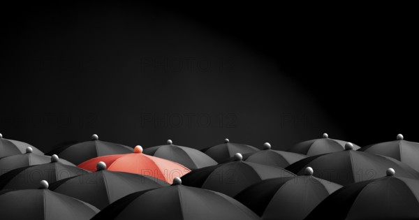 Concept image with lots of black umbrellas and a red umbrella that stands out, be unique