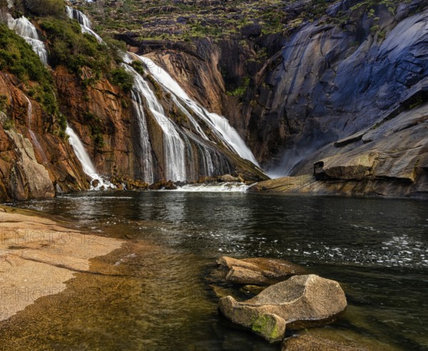 A beautiful waterfall in Ezaro cascading directly into the ocean