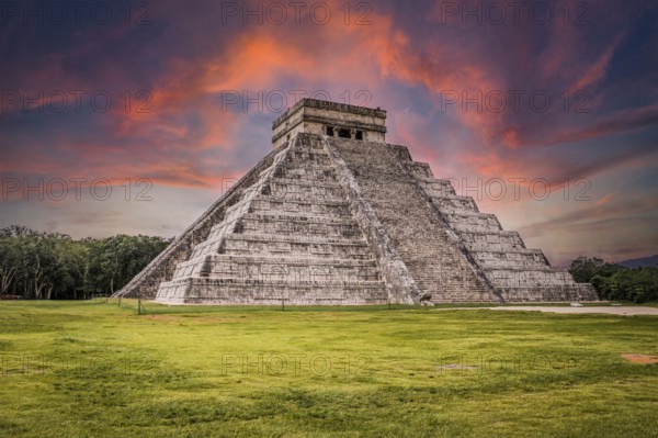 Beautiful clouds at sunrise over the famous Maya pyramid in Yucatan, Mexico that attracts millions of visitors