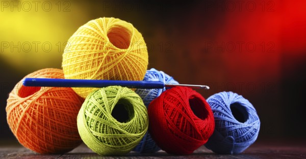Composition with assortment of different colored yarns and hook for crocheting