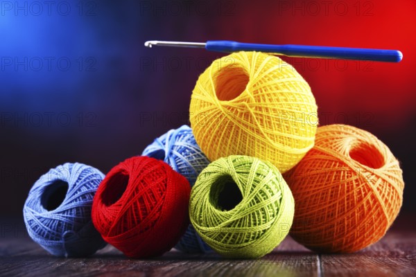 Composition with assortment of different colored yarns and hook for crocheting