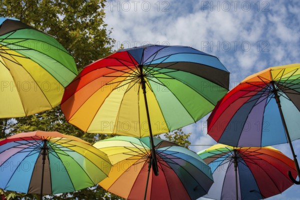 Rows Umbrellas floating above the street protecting from Sunlight