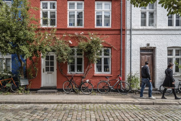 Copenhagen, Denmark, August 12, 2016. Picturesque old brick colorful houses in historical city centre of Copenhagen a cloudy day of summer, with bicycles parked, Europe