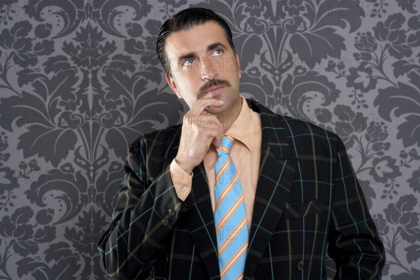 Mustache retro salesman with vintage suit and pensive gesture in wallpaper