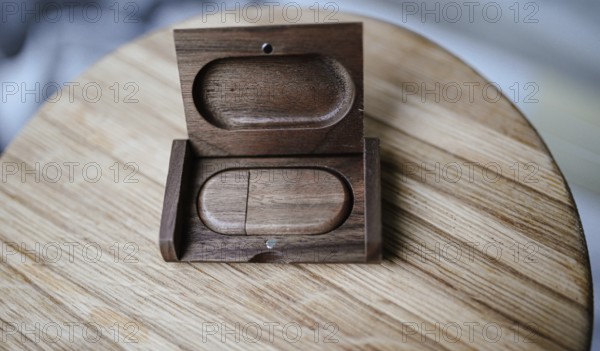 An open wooden case with light wood and minimal style on a wooden tabletop, highlighting natural grain