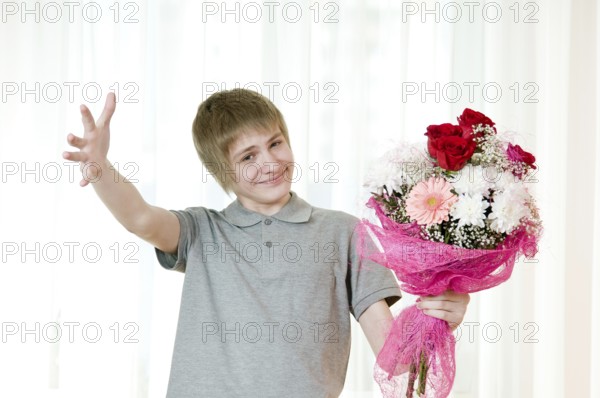 Good-natured young man with a bouquet of flowers
