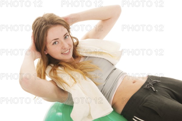 Sport woman with ball training the abs isolated over white background