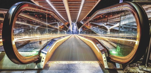 Illuminated escalator, reflected symmetrically in glass walls, Liège-Guillemins railway station, Liège-Guillemins, Belgium, Europe