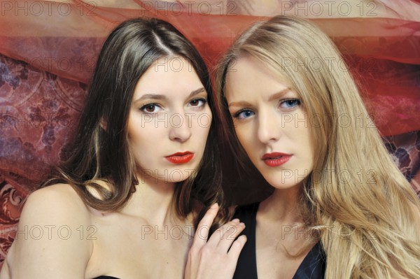 Portrait of the two beautiful women in an oriental interior