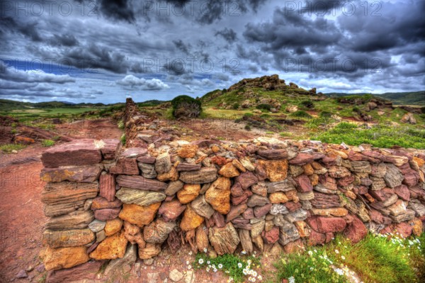 Masonry stonewall in spring with flowers at Menorca Balearic islands