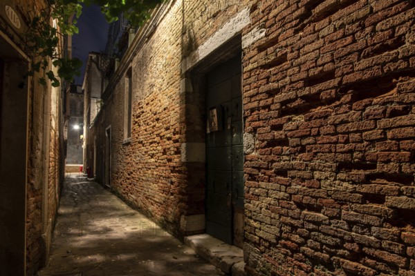 Old Brickwall in a narrow Alley in Cannaregio District, Venice, Italy, Europe