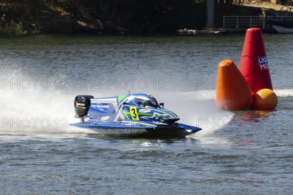 PESO DA REGUA, PORTUGAL - SEPTEMBER 15, 2024: Blue Powerboat Goes Fast with Splashes of Water during Race. Red Buoy. Formula 2 World Championship
