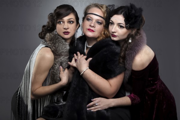 Three woman in vintage style. The people are stylised for the era of the 20s or 30s