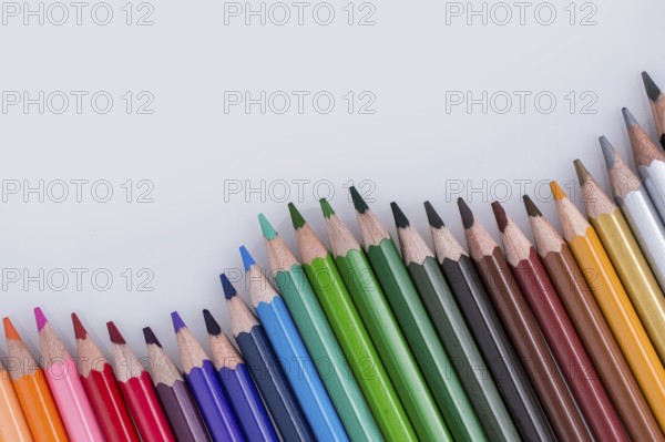 Color Pencils of Various colors placed on white background