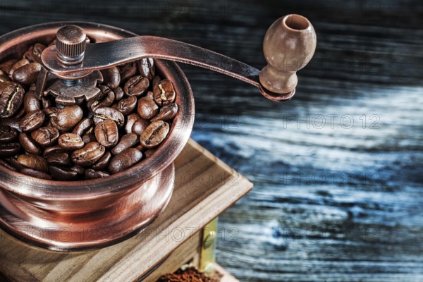 Coffee mill seeds on wooden board
