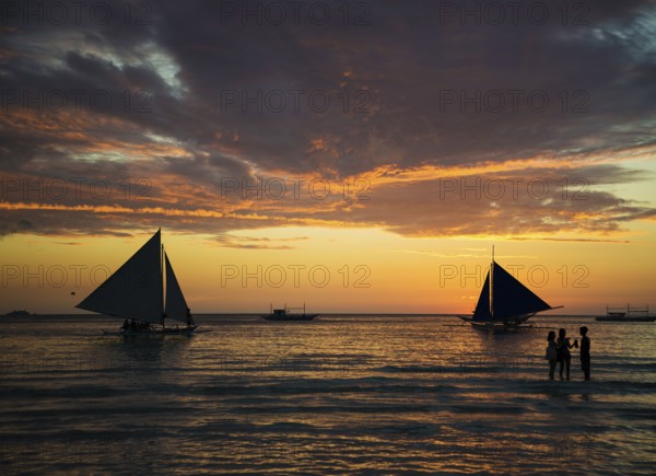 Sailing boats at sunset on boracay island beach philippines