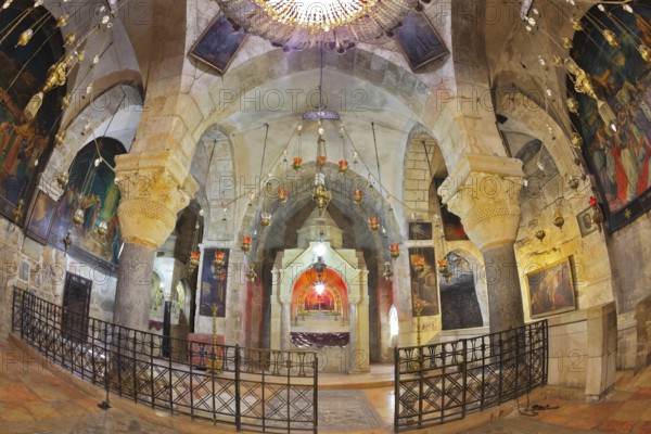 Jerusalem - September 3: Hall of the Holy Sepulchre in September 3, 2012 in Jerusalem. Ornate underground hall in the Temple. Marble columns, semicircular niche - the altar, ancient paintings of biblical scenes