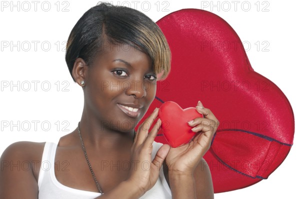 A beautiful young African American black woman holding a Valentines Day heart