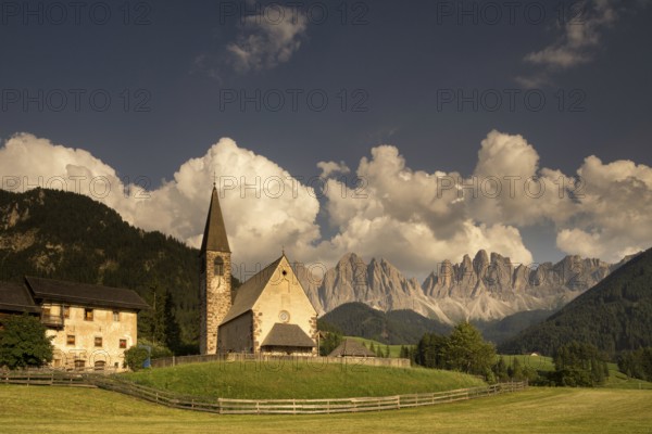 The Sankt Magdalena church in front of the Geislergruppe mountain tops in the Italian Dolomites
