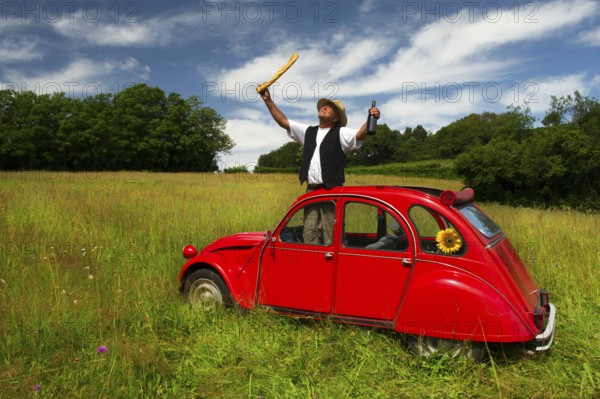 Typical French man with bread wine and his car