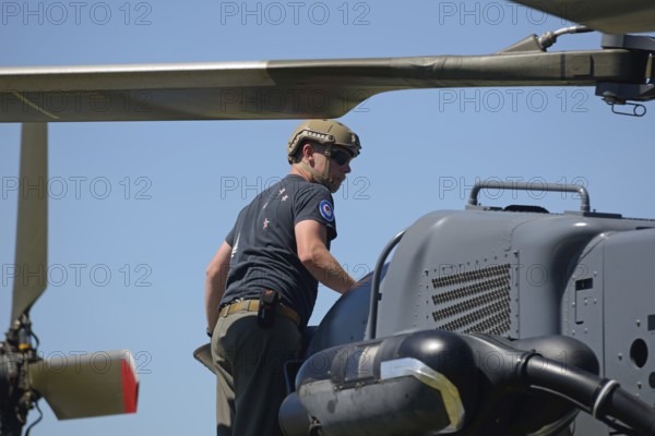 GREYMOUTH, NEW ZEALAND, NOVEMBER 18, 2017: A pilot makes a preflight check on an Air Force NH90 helicopter at an open day run by the New Zealand armed forces. The NH90 was built by NATO Helicopter Industries (NHI) France