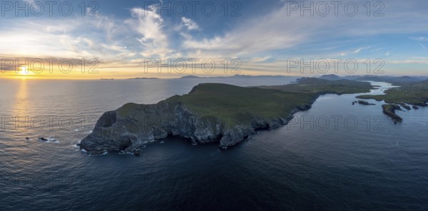 An aerial panorama view of the Bray Head cliffs and headland on Valentia Island at sunset
