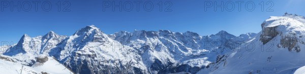 Various alpine peaks including Eiger, Moench, and Jungfrau, seen from the skiing resort Schilthorn high above Muerren, Switzerland, Europe