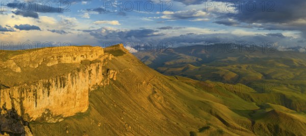 Aerial panorama view of plateau Bermamyt and hills at sunset, North Caucasus mountains, Russia, Europe