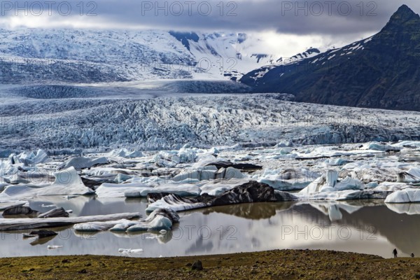 Cold summer in the Arctic. Jokulsarlon glacial lagoon. An imposing scenic lagoon in the north of Iceland. Glaciers and icebergs among cold mountains. Iceland