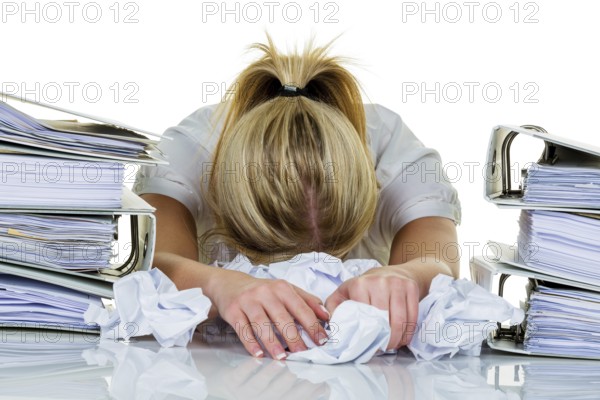 Young woman in the office is overwhelmed with work. burnout syndrome at work or study. Austria