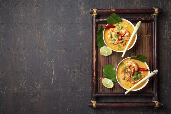 Food, Food, Shrimps Tom Yam Kung in grey bowl with thai spices on autentic tray top view, wooden background