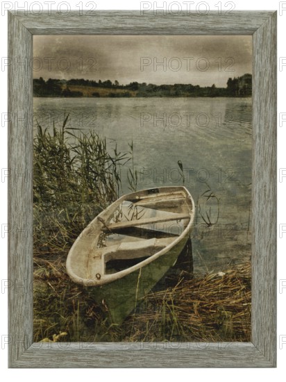 Decorative old photo of boat at lake in wooden frame